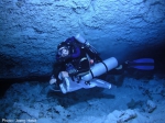 Rebreather diver towing a plankton net at the halocline (note blurry mixing of fresh and salt water behind the diver) in a Yucatan cave.